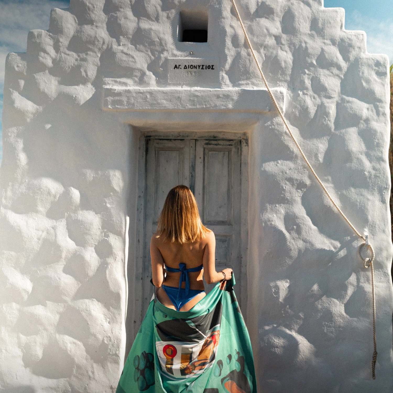 One Zipper microfibre beach towel in a Greek island setting